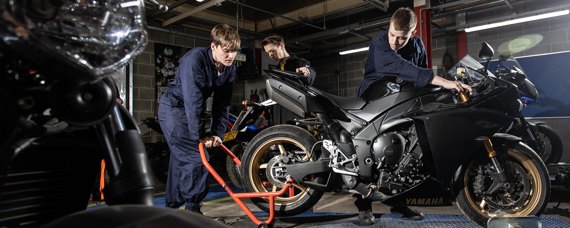 Students working on a motorbike