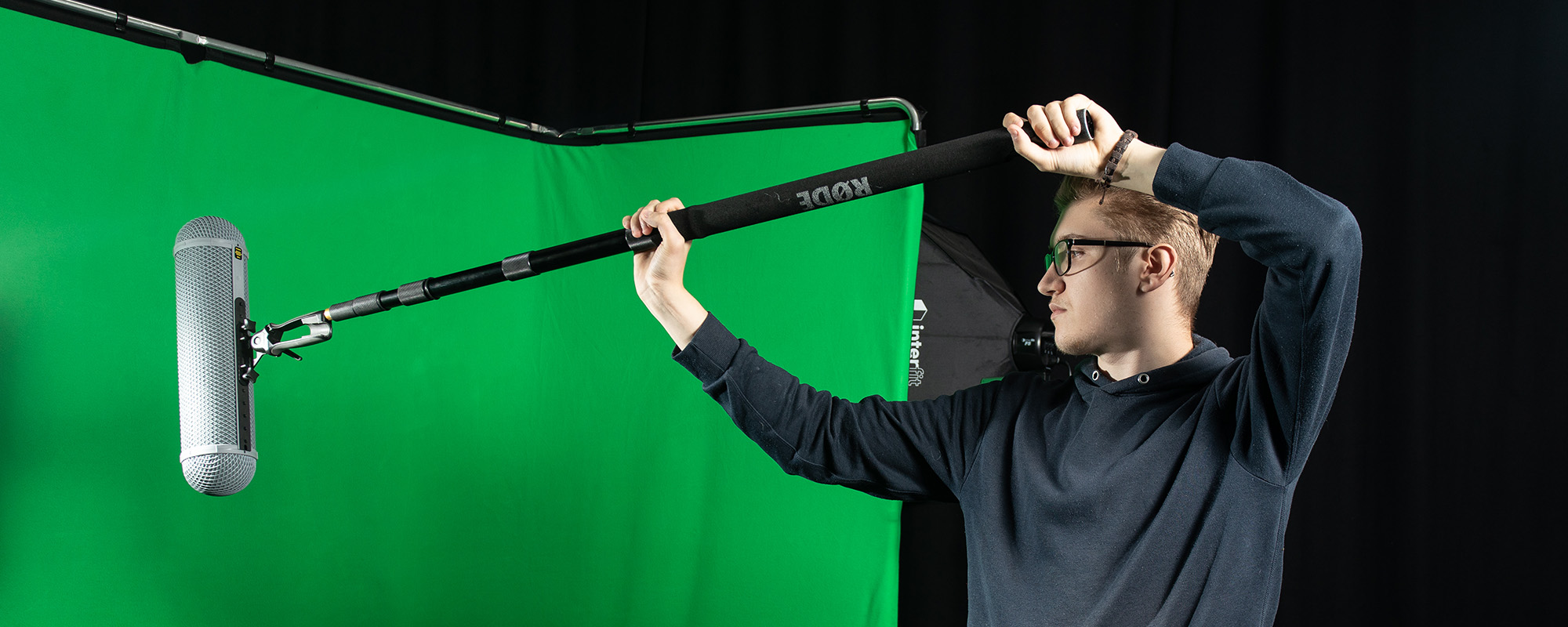 Media student editing videos in an editing suite