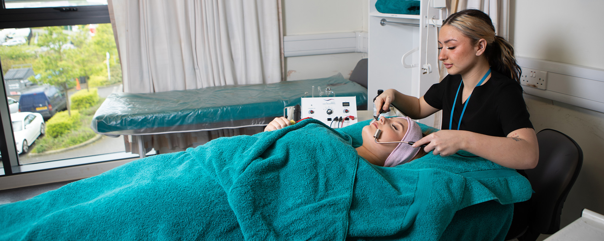 Beauty student with a client during a treatment