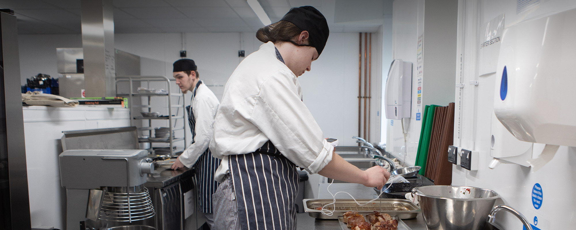 Two students working in a kitchen