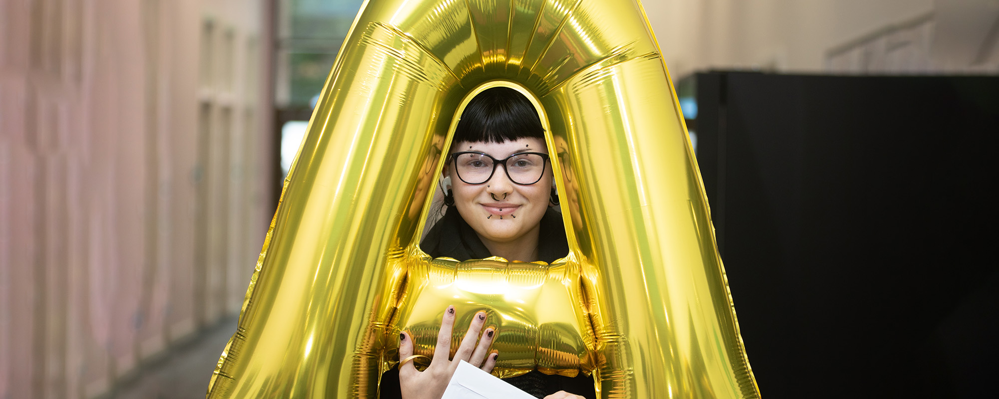 A Level student holding her results