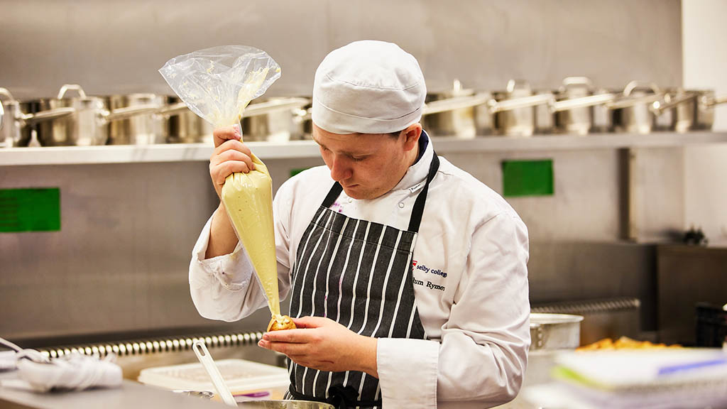 Catering student Callum preparing some food 