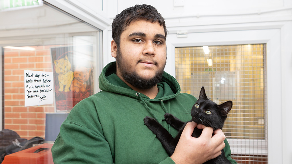 Student holding a cat