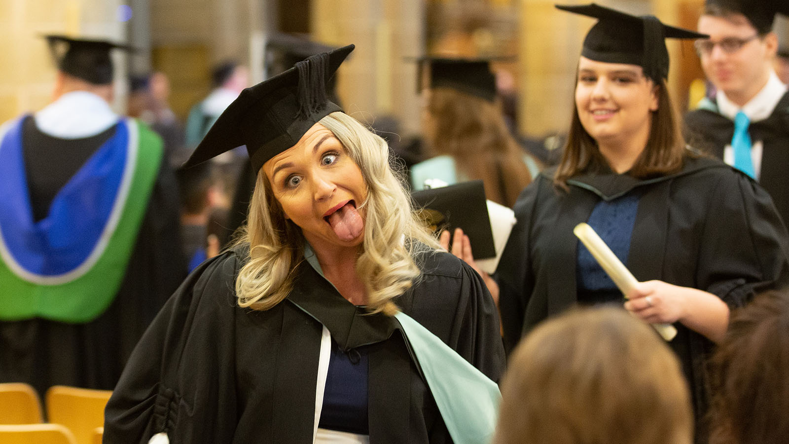 Happy graduates collecting their awards