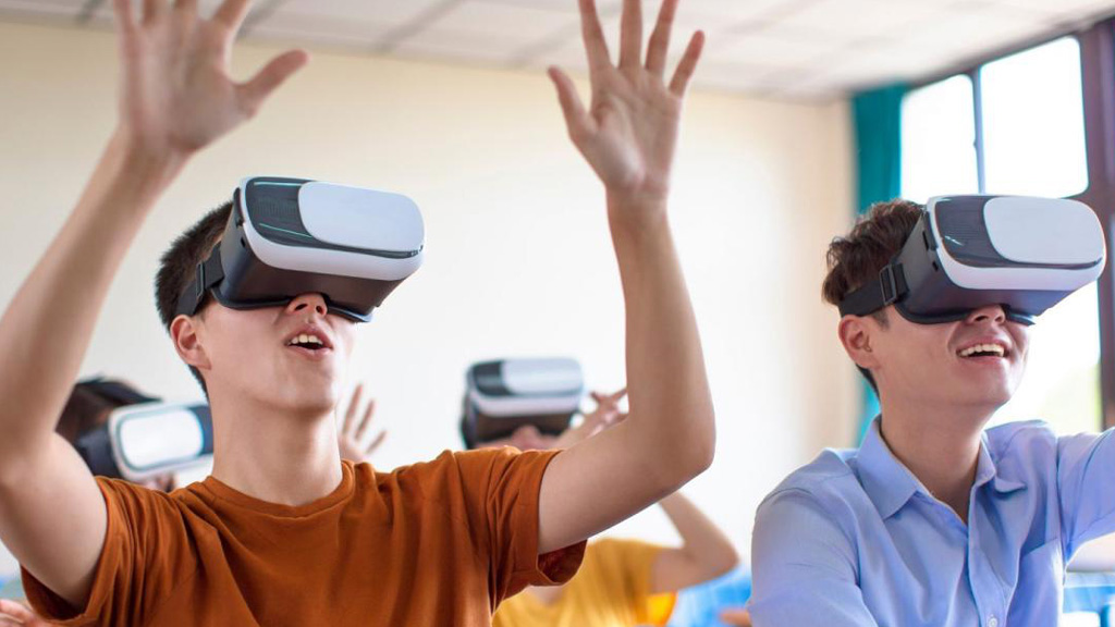 Two students wearing VR headsets