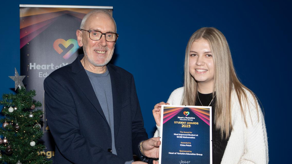 Andrew McConnell OBE presenting student award winner Chloe