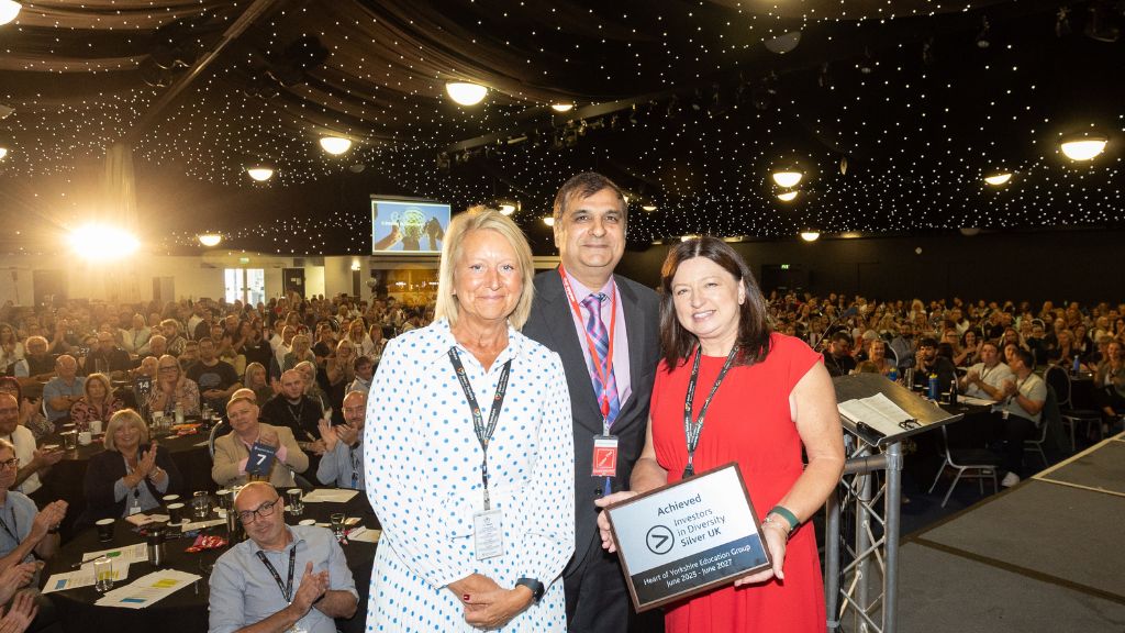 Solat Chaudhry (middle) presenting Principal Sam Wright (left) and Group Executive Director for People, Karen Sykes (right) presenting the Group with its Silver accreditation