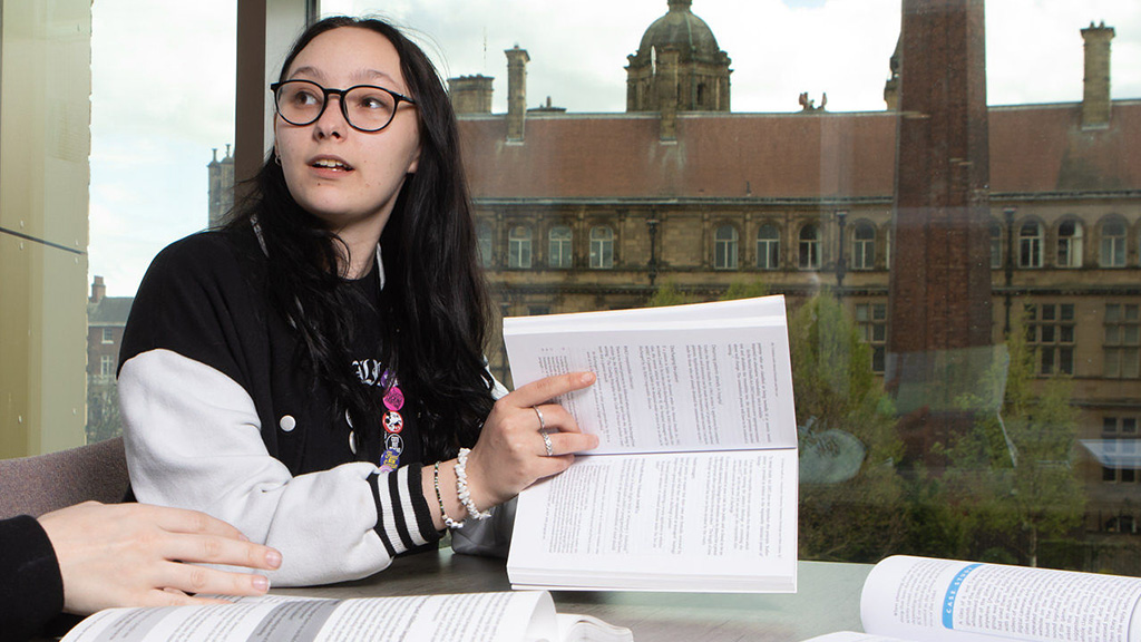 Photo of student working with notebooks