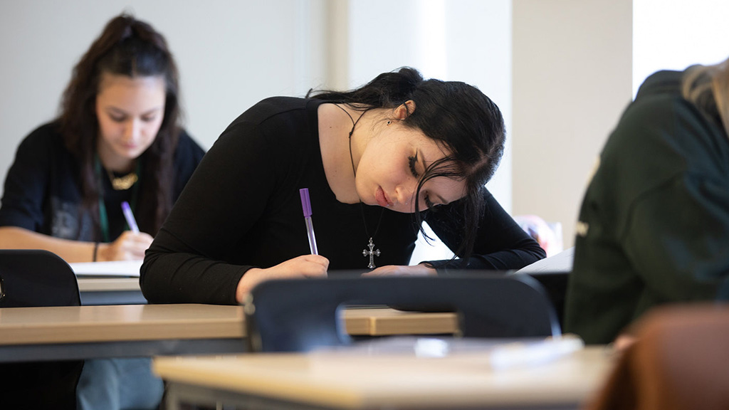 Female student writing in class