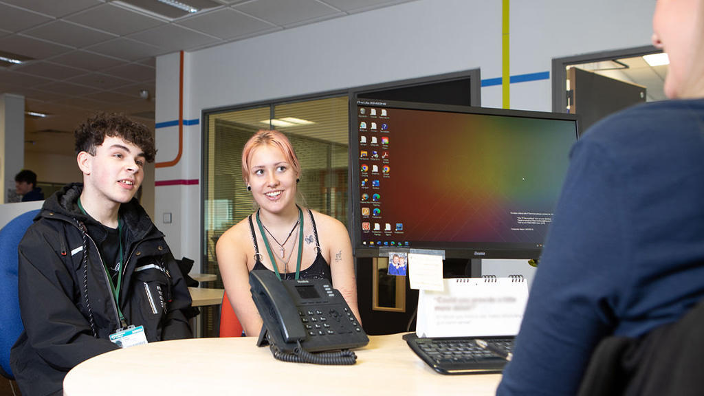 Two students talking to a student advisor