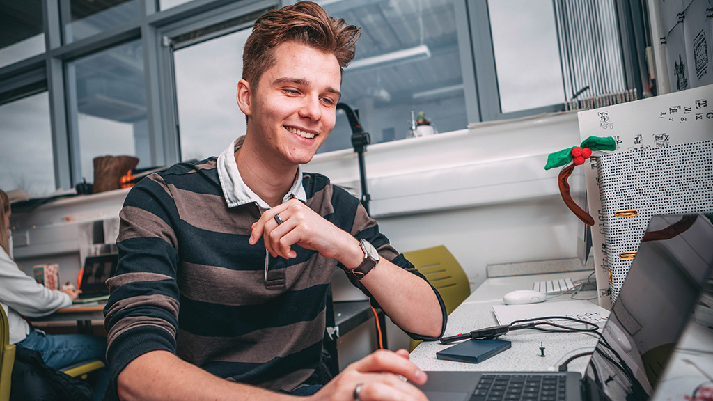 Student doing design work on a laptop