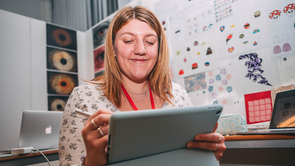 Student doing design work on an tablet