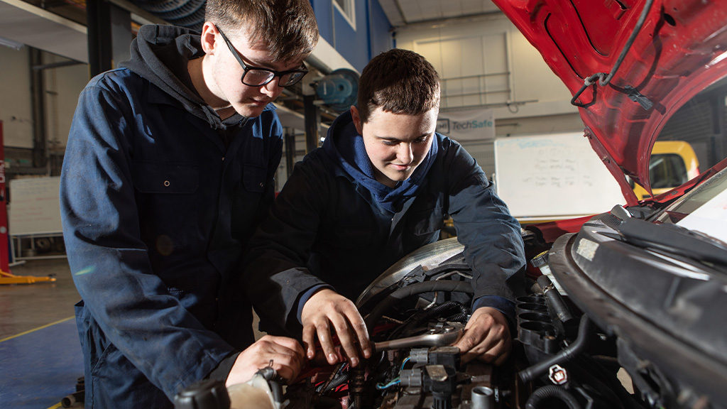 Students working under the bonnet of a car