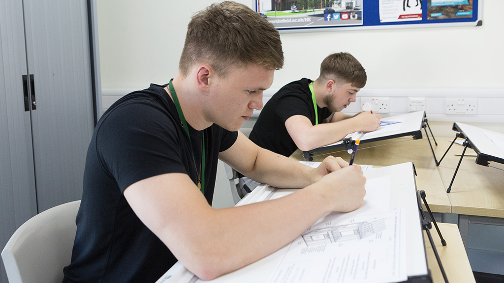 Students in classroom with architectural drawings