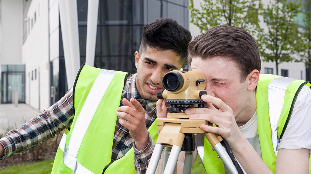 Students using surveying equipment