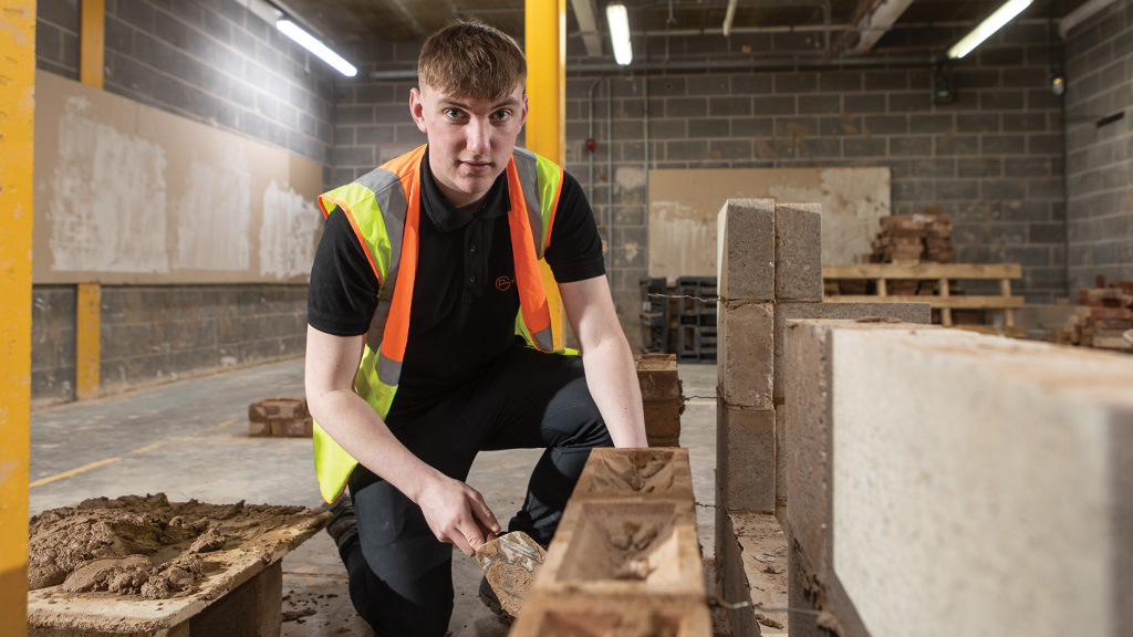 Student laying bricks