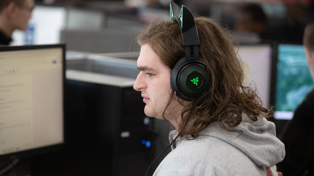 Student with headphones working on a PC