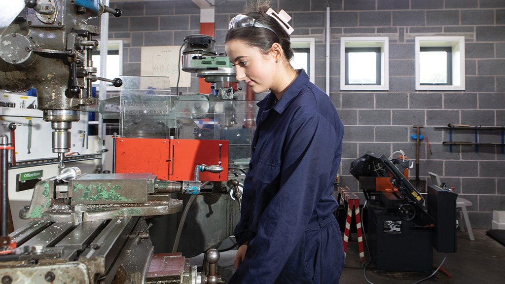 Student using engineering machinery