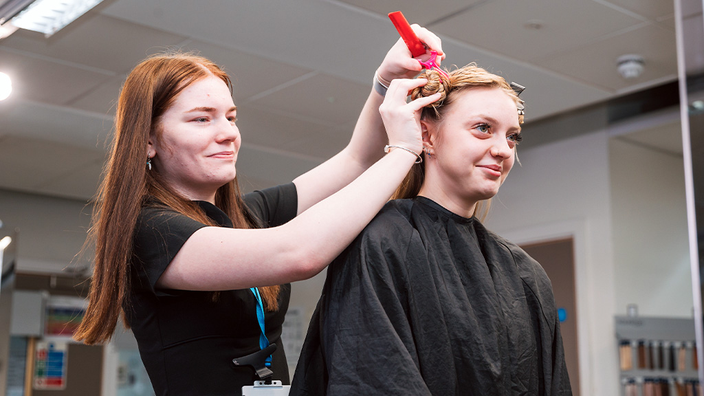 Student working on a hairdressing client