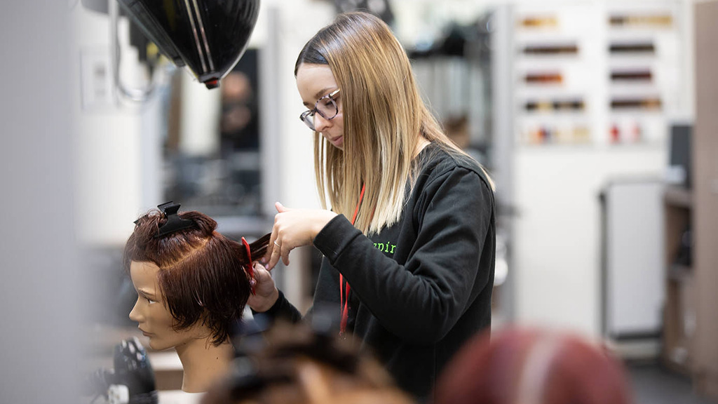 Student practising hairdressing techniques