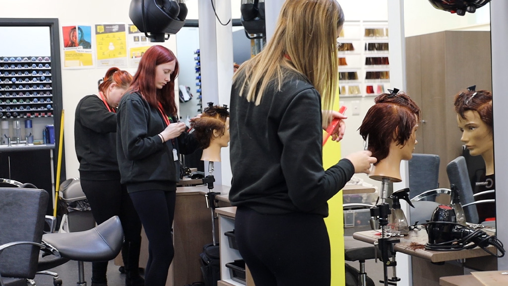 Students practising hair styling 