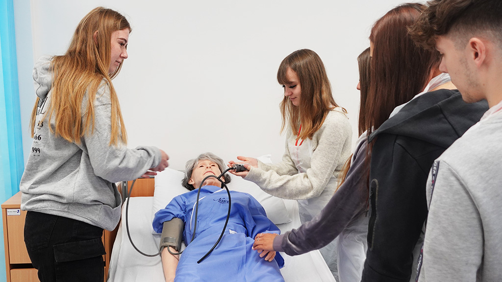 Healthcare student and tutor working in mock hospital