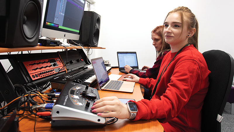 Group of students working in a music studio