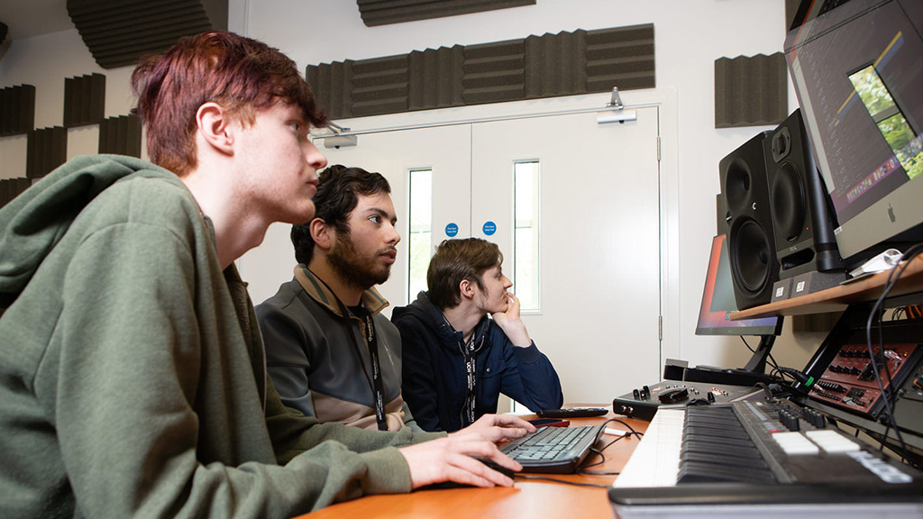 Group of students working in a music studio