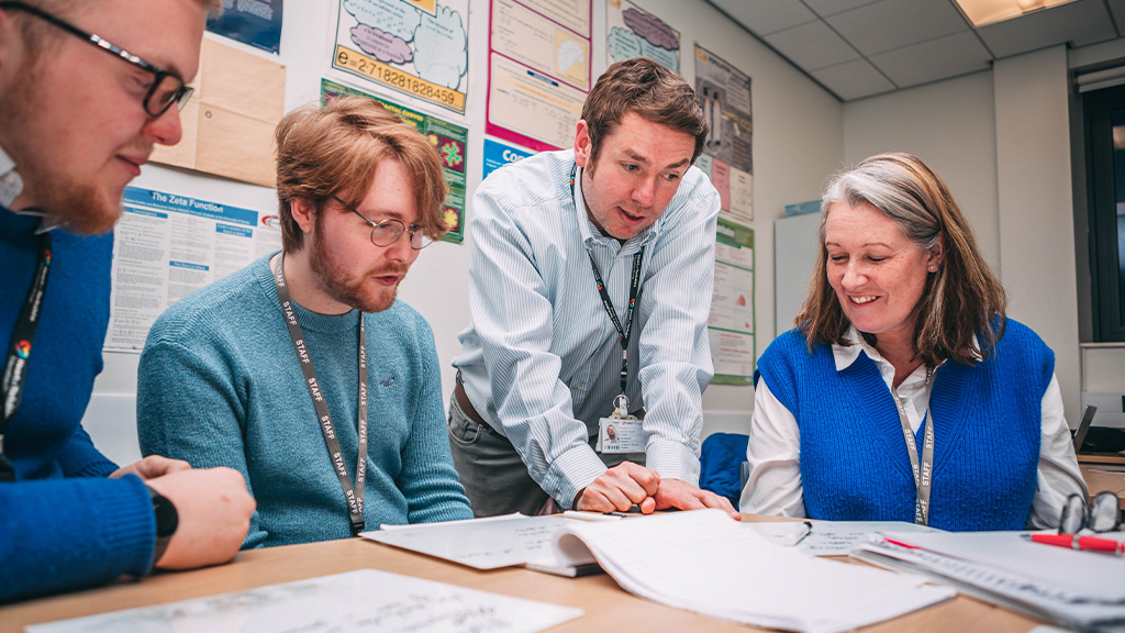 Students and tutor around table